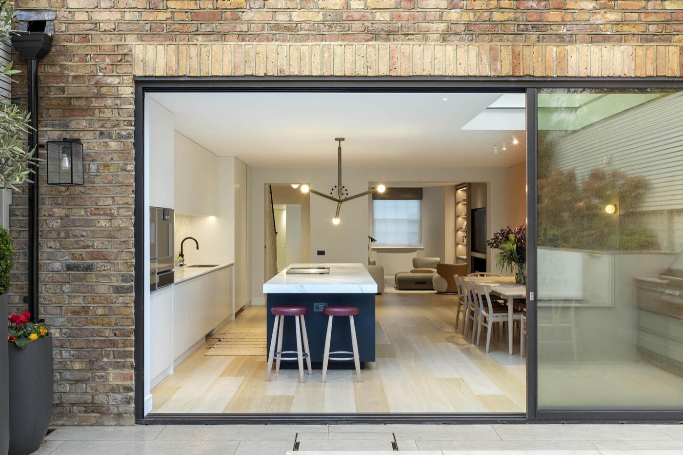 A townhouse rear extension with a wide sliding opening onto the garden
